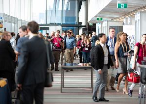 People standing and walking into a conference