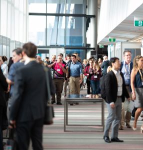 People standing and walking into a conference