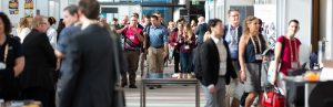 People standing and walking into a conference