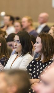 Two young women watching intensely